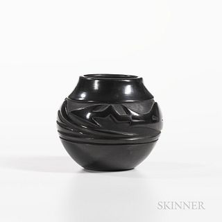 Contemporary Carved Blackware Pottery Jar, Santa Clara Pueblo, signed "Severa," for Severa Tafoya, with a deeply carved "Avanyu" design
