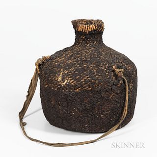 Southwest Basketry Water Jar, Apache, c. 1900, the flat-bottom form with high shoulder, small neck, two wood lugs with fabric strap, an