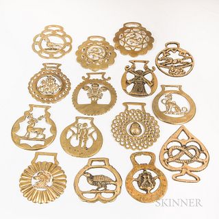 Fifteen Horse Brasses, incorporating figural designs including animals, a windmill, an acorn, and a fleur-de-lis.