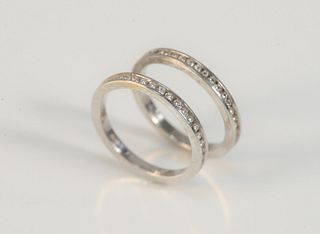 Two Hidalgo 18 Karat White Gold Bands
each with small channel set diamonds
size 6 1/2
5.5 grams