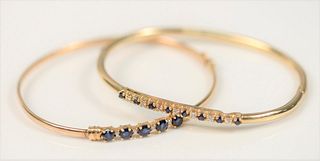 Two 14 Karat Gold Bangle Bracelets
each set with blue sapphires and diamonds
11 grams
57.6 millimeters