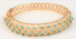14 Karat Gold Bangle Bracelet
with open work and mounted with small turquoise beads
31.6 grams
59.4 millimeters