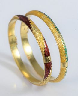 Two 18 Karat Gold and Enamel Bracelets
one green, one red enameling
each chipped
57 millimeter interior
51.6 grams