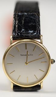 Tiffany & Company 14 Karat Gold Men's Wristwatch
with 14 karat gold, and leather band
30.5 millimeters
Provenance: The Estate of Andrew Wolf, New Have