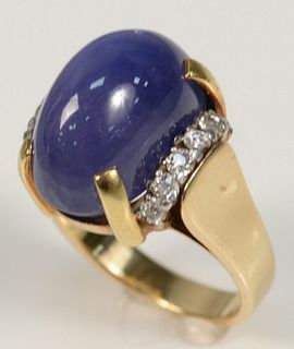 18 Karat Yellow Gold Ring
set with large purple cabochon cut star sapphire, flanked by six diamonds on either side
size 7 1/2
13.9 grams
star sapphire