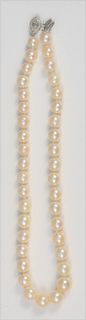 Pearl Single Strand Necklace 
of graduating pearls with white gold clasp 
set with marquise diamond, approximately .50 carat
surrounded by small diamo