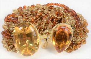 18 Karat gold and beaded bracelet
with clasp mounted with large oval citrines, surrounded by small diamonds
length 8 inches