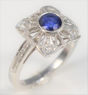 18 Karat White Gold Ring
with center blue sapphire, with diamond surround, and diamonds in band
size 6