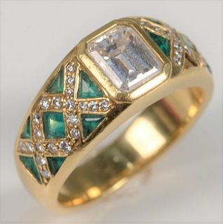 18 Karat Yellow Gold Ring
set with emerald cut diamonds, flanked by cross thatched diamonds, centered with emeralds
size 6
center diamond approximatel
