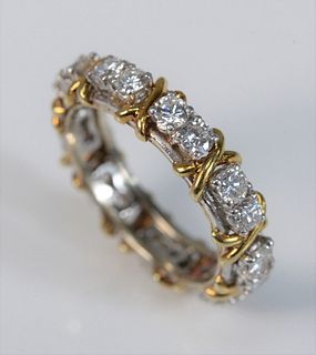 18 Karat and Platinum Hugs and Kisses Diamond Eternity Band
with sets of two diamonds alternating with gold X's in between set of diamonds
18 round cu