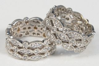 Pair of 18 Karat White Gold Bands
with open work, and completely set with diamonds
width 5/16 inches each
14.2 grams total