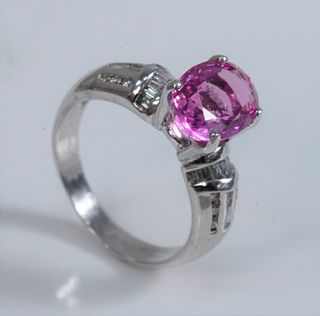 18 Karat White Gold Ring 
with oval pink sapphire, flanked by trillion cut, and round cut diamonds
size 6
sapphire 9.9 x 7.4 millimeters