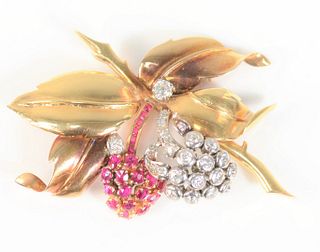 18 Karat Gold Brooch Flower and Leaf Form
set with 23 diamonds and 21 rubies
length 2 1/4 inches
19.8 grams