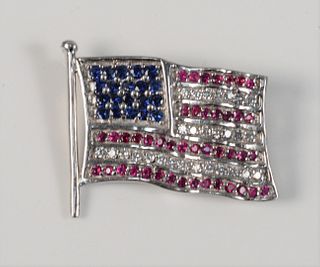 18 Karat White Gold Flag Pin
set with twenty sapphires, four rows of rubies, and three rows of diamonds
length 1 1/8 inches
12.9 grams