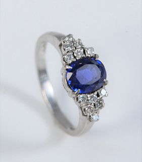 Platinum Ring 
set with center oval blue stone, flanked by six diamonds on either side
size 6