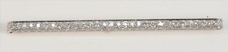 Tiffany & Company Platinum and Diamond Bar Pin
set with thirty diamonds, in original Tiffany & Company box
approximately 3 carats
length 3 1/2 inches
