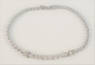 14 Karat White Gold and Diamond Tennis Bracelet
set with eighty-three diamonds, round brilliant and baguettes
length 9 1/2 inches
12.7 grams