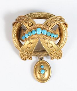 14 Karat Gold Victorian Brooch
set with turquoise, hung with small hair locket
10 grams
