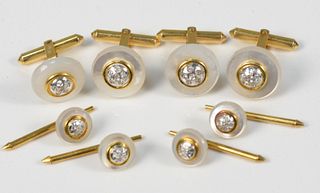 14 Karat Gold Set
to include two pair of cufflinks, along with four buttons, each with mother of pearl, set with diamonds
total weight 29.5 grams