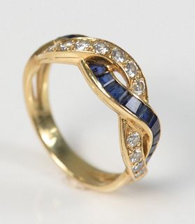 Tiffany & Company 18 Karat Gold Ring
with intertwined band of diamonds, and blue sapphires
size 6 3/4
3.9 grams
