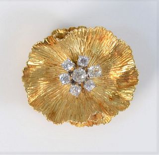 18 Karat Gold Flower Brooch
set with seven diamonds
1 1/4" x 1 3/8"
19.8 grams