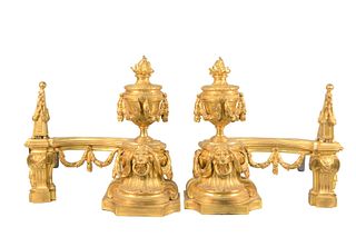 Pair of Late Louis XV Ormolu Chenets
circa 1770, each with flaming urn, and lion's mask, with berried garland swags
height 17 inches, width 18 1/2 inc