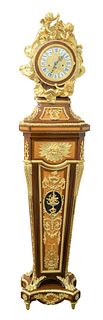 Regency Style Tall Case Clock
having gilt bronze puttis surrounding circular dial on inlaid and gilt bronze case, base with round legs ending in paw f