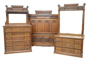 Three Piece Aesthetic Walnut Bedroom Set having carved high back bed, three drawer chest with mirror, five drawer tall chest with mirror and shelf bot