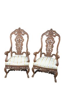 Pair Walnut Continental Style Armchairs
with pierce carved backs, and skirts on carved legs, with scroll stretchers
height 54 inches
Provenance: Matth