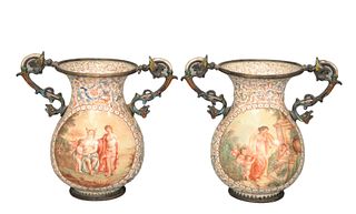Pair of Viennese Enameled Silver Urns having partially clad figures and Putties, enameled, winged griffin handles, one chip at handle attachment and r