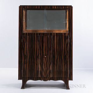 Art Deco Rosewood China Cabinet, France, c. 1930, mirrored storage with glass shelf behind sliding glass doors over locking two-shelved