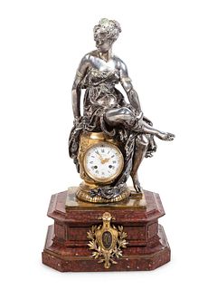 A Napoleon III Gilt and Silvered Bronze and Rouge Griotte Marble Figural Clock