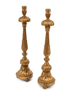 A Pair of Italian Neoclassical Carved and Parcel Gilt Candlesticks