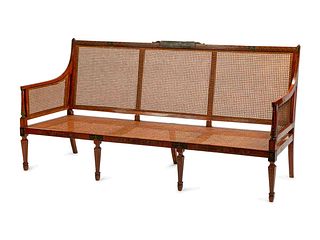 An Edwardian Painted Satinwood Caned Settee