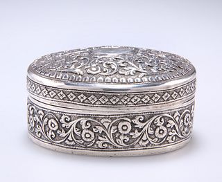 AN INDIAN OVAL BOX, 19TH CENTURY, chased with scrolling fol