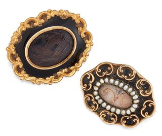 TWO VICTORIAN HAIRWORK AND ENAMEL MOURNING BROOCHES, the fi