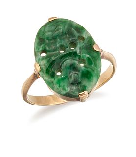 A 9CT GOLD NEPHRITE RING, the oval carved and pierced nephr