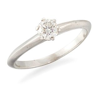 A SOLITAIRE DIAMOND RING, a round brilliant-cut diamond in 