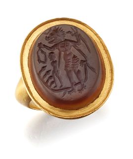 AN 18CT GOLD CARNELIAN INTAGLIO SIGNET RING, the oval intag