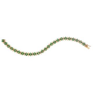 18K YELLOW GOLD BRACELET WITH EMERALDS AND DIAMONDS Box clasp with 8-shape safety. Weight: 23.8 g. Length: 7.5" (19.1 cm)