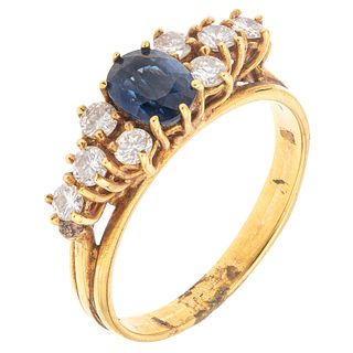 RING WITH SAPPHIRE AND DIAMONDS IN 18K YELLOW GOLD Weight: 3.8 g. Size: 7 ¼ 1 Faceted oval cut sapphire ~ 0.60 ct 