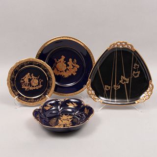 Lote de 4 platos. Alemania y Francia. Siglo XX. Diferentes diseños. Elaborados en porcelana Limoges y uno Bavaria color azul cobalto.