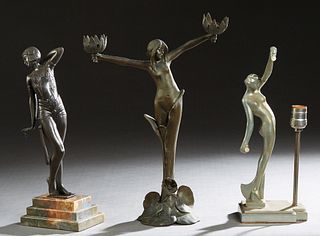 Group of Three Spelter Figures, 20th c., consisting of an art nouveau patinated figural lamp, with a lilypad base; a deco style metal dancer on a step