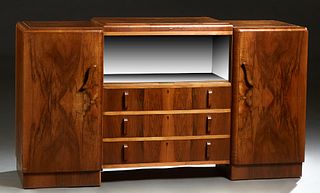 English Carved Walnut Art Deco Sideboard, c. 1940, the raised center section with two sliding glass doors, over a bank of three drawers, flanked by lo