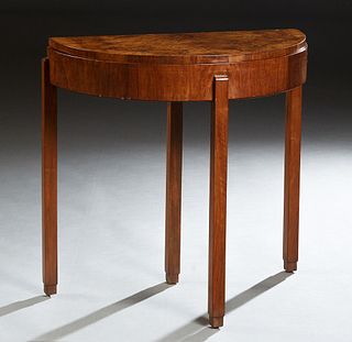 English Art Deco Carved Walnut Demilune Table, c. 1940, the highly figured top over a wide skirt with a rear drawer, on rectangular legs, H.- 30 in., 