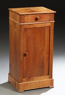 French Louis Philippe Carved Cherry Nightstand, 19th c., the rectangular top over a frieze drawer and a cupboard door, on a plinth base on block feet,