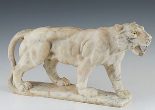 Carved Alabaster Lioness Figure, 20th c., with yellow glass eyes, on an integral base, H.- 7 3/4 in., W.- 16 in., D.- 3 1/2 in. Provenance: from the E