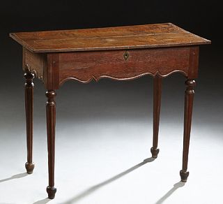 French Provincial Louis XVI Style Carved Oak Console Table, 19th c., the hinged lifting lid over open storage, above a scalloped skirt, on turned tape