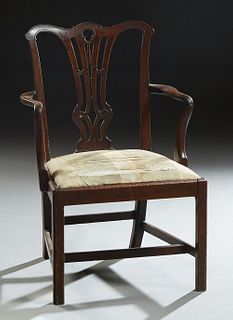 English Chippendale Style Carved Mahogany Armchair, 19th c. ,the arched crest rail over a pierced backsplat, to curved arms over trapezoidal slip seat