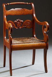 American Carved Mahogany Armchair, late 19th c., the canted back with a rope twist crest rail and a horizontal splat with a nut and leaf carved basket